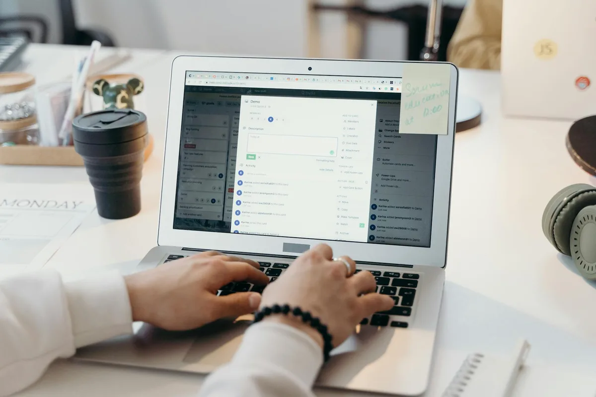 A solo creator typing on a laptop at a bright, modern workspace, focused on email marketing