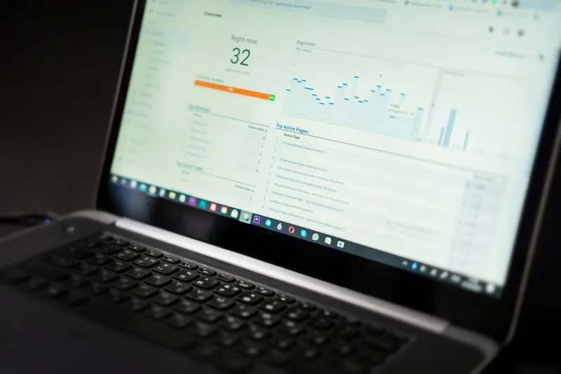 A laptop displaying an analytics dashboard with real-time email performance data