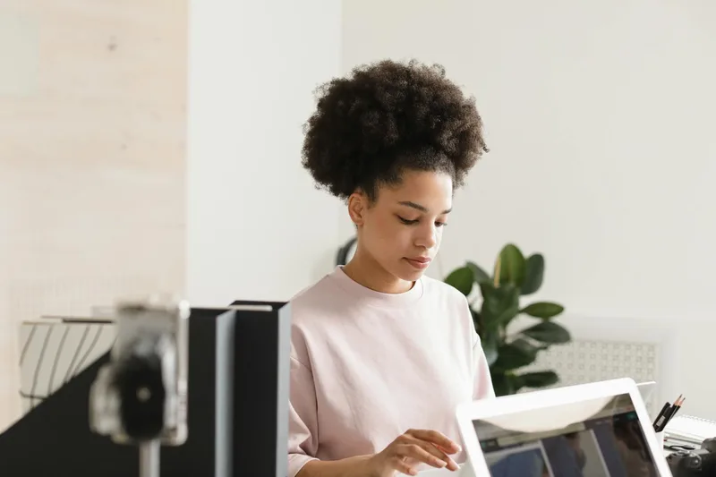 Creator working on a computer reviewing campaign metrics and email performance data