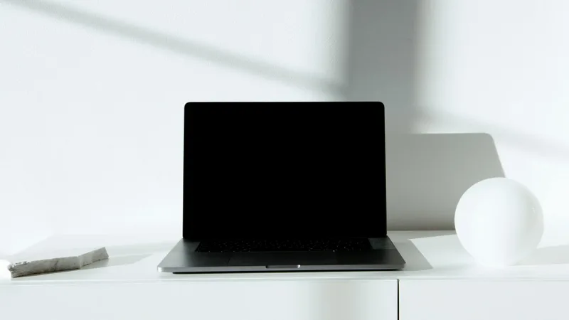Clean webinar registration page on a laptop screen, minimal design with clear headline and two-field form
