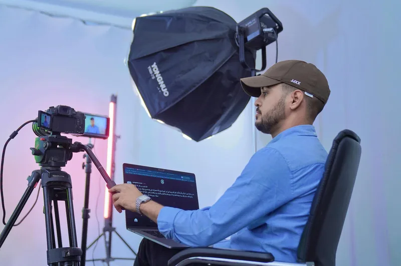 Creator reviewing video footage on a laptop at a desk representing the editing and review process for a VSL video