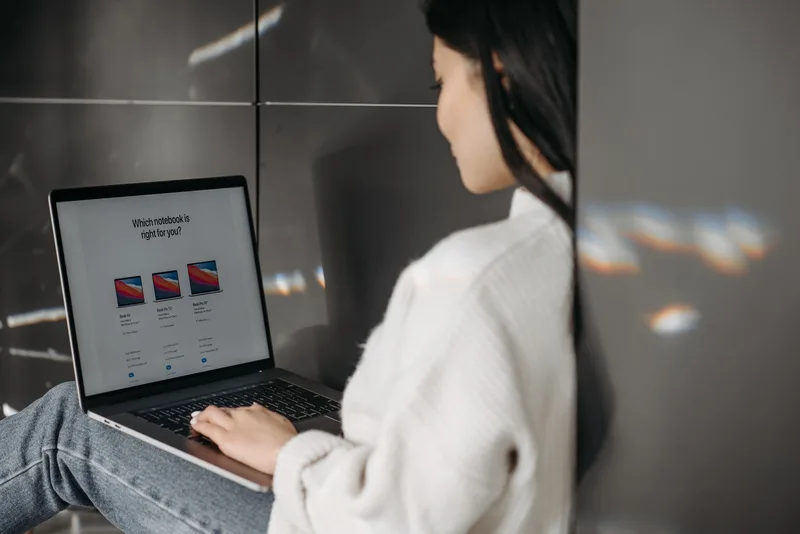 A solo creator at a desk with two browser tabs open comparing dashboards side by side